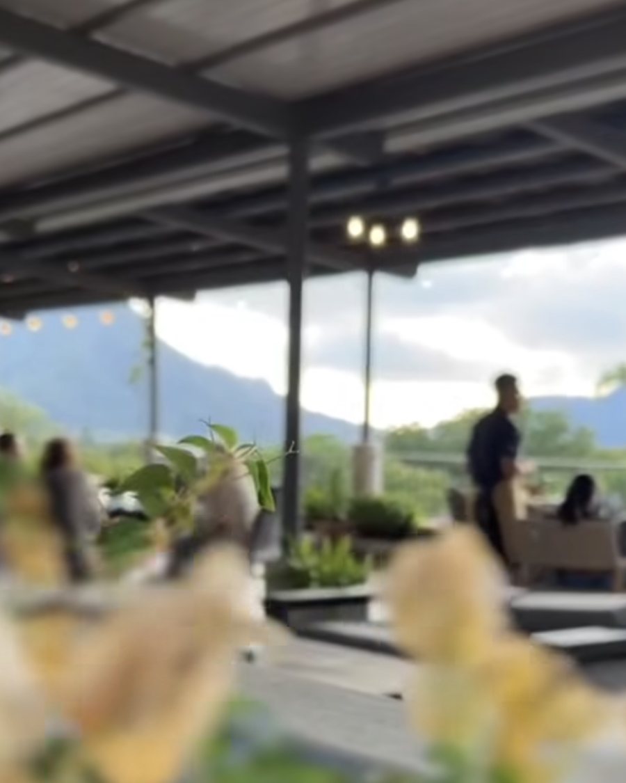 The open-air Viento terrace with string lights, looking out to the mountains